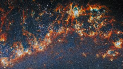 Webb infrared view of star-forming regions in the M51 galaxy, where the FEAST programme studied thousands of young star clusters.