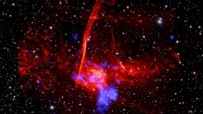 Composite image of Sagittarius C near the Milky Way's Galactic Center: X-rays from Chandra and XMM-Newton (blue), radio data from MeerKAT (red), and optical light from Pan-STARRS, marking a possible supernova remnant.