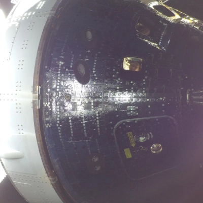 art002e009014 (April 42026) - Artemis II Mission Specialist Christina Koch (center) and Commander Reid Wiseman (top) are seen through...