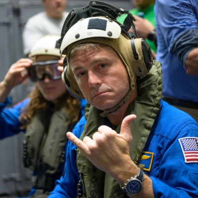 NASA astronaut Reid Wiseman, commander of the Artemis II mission gives a shaka hand gesture as he and NASA astronaut...