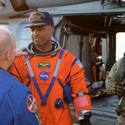 NASA astronaut Victor Glover, Artemis II pilot shakes hands with Scott Tingle, Chief of the Astronaut Office as he is...