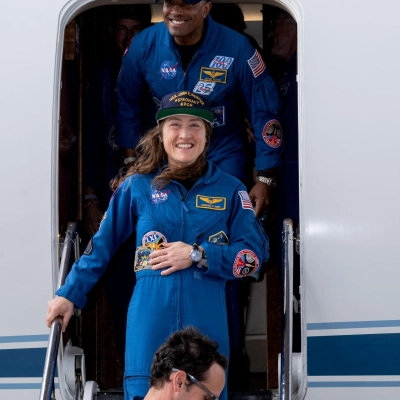 jsc2026e022269 (April 11, 2026) - Artemis II Pilot Victor Glover (top) and Mission Specialist Christina Koch (center) return home to...