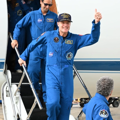 jsc2026e022272 (April 11, 2026) - Artemis II Mission Specialist Jeremy Hansen returns home to Houston, stepping off a plane at...