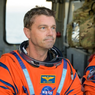 NASA astronaut Reid Wiseman, Artemis II commander is seen sitting in a Navy MH-60 Seahawk from Helicopter Sea Combat Squadron...