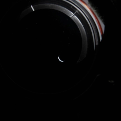 art002e009174 (April 3, 2026) - Peering out the window of the Orion spacecraft at a sliver of the Earth illuminated...