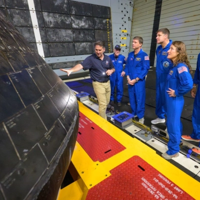 NASA Orion Vehicle Integration Manager Louis Saucedo, left, inspects the Orion spacecraft with NASA Flight Surgeon Richard Scheuring, NASA astronaut...