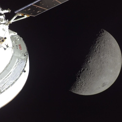 art002e009566 (April 6, 2026) - NASA’s Orion spacecraft is seen in the foreground, lit up by the Sun. A first...