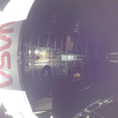 art002e009008 (April 42026) - Artemis II Mission Specialist Jeremy Hansen is seen through a window of the Orion spacecraft...