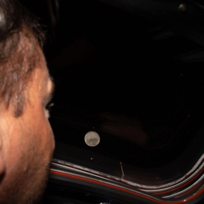 art002e009275 (April 6, 2026) - Artemis II commander and NASA astronaut Reid Wiseman looks out one of the Orion spacecraft's...