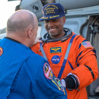 NASA astronaut Victor Glover, Artemis II pilot shakes hands with Scott Tingle, Chief of the Astronaut Office as he is...