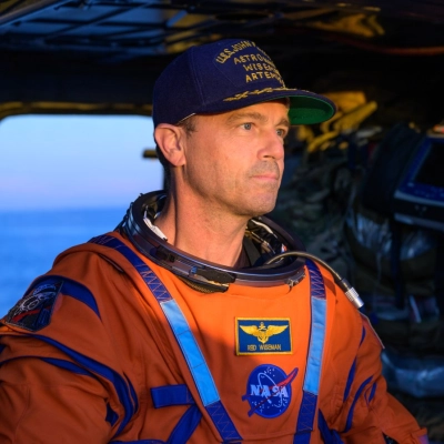 NASA astronaut Reid Wiseman, Artemis II commander is seen sitting in a Navy MH-60 Seahawk from Helicopter Sea Combat Squadron...