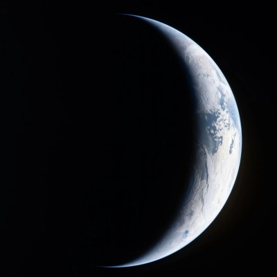 art002e004462 (April 4, 2026) - A sliver of Earth is illuminated against the blackness of space in this photo taken...