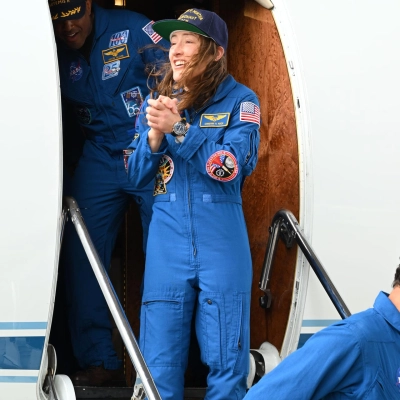 jsc2026e022273 (April 11, 2026) - Artemis II Mission Specialist Christina Koch returns home to Houston, stepping off a plane at...