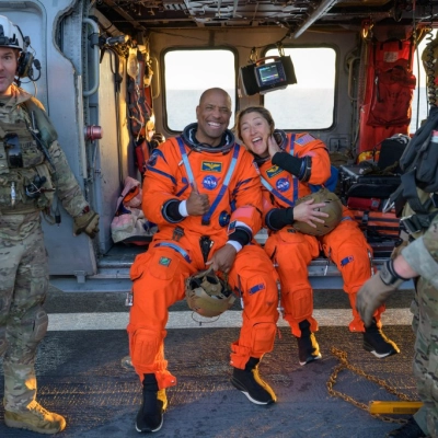 NASA astronaut Victor Glover, Artemis II pilot, left, and NASA astronaut Christina Koch, Artemis II mission specialist are seen sitting...
