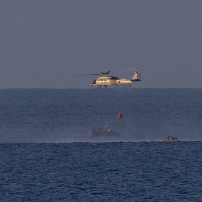 A Navy MH-60 Seahawk from Helicopter Sea Combat Squadron (HSC) 23 is seen as it lifts NASA astronaut Victor Glover,...