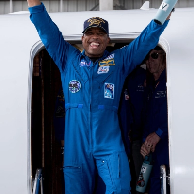 jsc2026e022270 (April 11, 2026) - Artemis II Pilot Victor Glover returns home to Houston, stepping off a plane at Ellington...