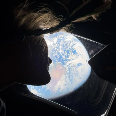art002e008487 (April 4, 2026) - NASA astronaut and Artemis II mission specialist Christina Koch peers out of one of the...