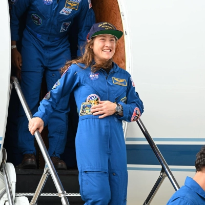 jsc2026e022274 (April 11, 2026) - Artemis II Pilot Victor Glover (top) and Mission Specialist Christina Koch (center) return home to...