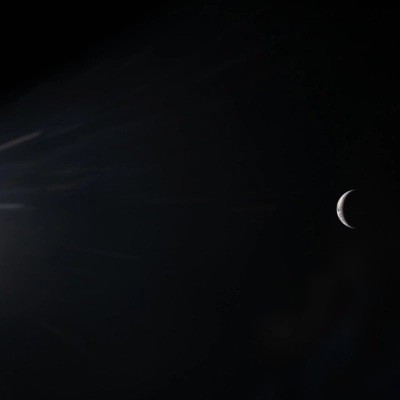 art002e00444 (April 3, 2026) - An illuminated sliver of Earth set against the blackness of space is seen through the...