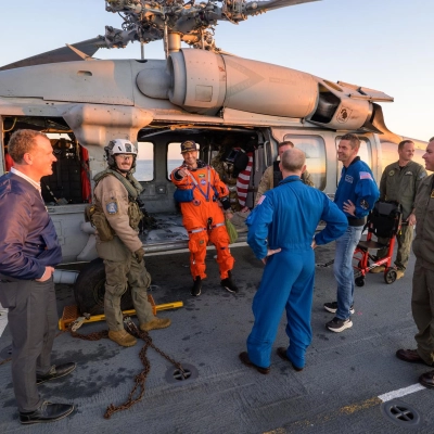 NASA astronaut Reid Wiseman, Artemis II commander is seen sitting in a Navy MH-60 Seahawk from Helicopter Sea Combat Squadron...