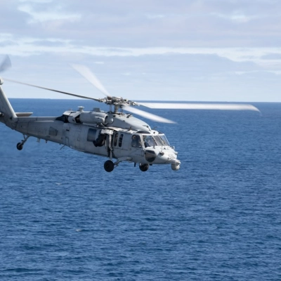 A U.S. Navy MH-60 Seahawk from Helicopter Sea Combat Squadron (HSC) 23 departs from the flight deck of USS John...