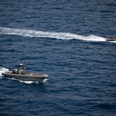 Small boats are seen alongside USS John P. Murtha as teams prepare to recover mission crewmembers crew and NASA’s Orion...
