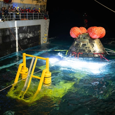 3]NASA’s Orion spacecraft is seen as the agency’s Landing and Recovery team, along with U.S. Navy personnel work to recover...