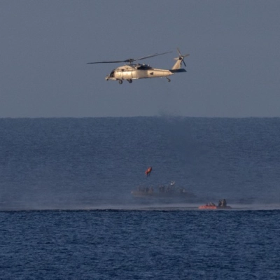 A Navy MH-60 Seahawk from Helicopter Sea Combat Squadron (HSC) 23 is seen as it lifts NASA astronaut Christina Koch,...