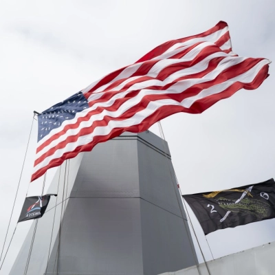Flags are seen aboard USS John P. Murtha as teams prepare to recover mission crewmembers crew and NASA’s Orion spacecraft...